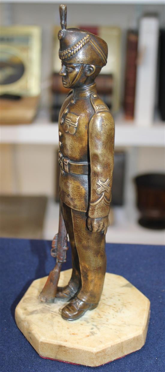 An early 20th century patinated military bronze model of a Kings Royal Rifle Corps soldier, 10.5in.